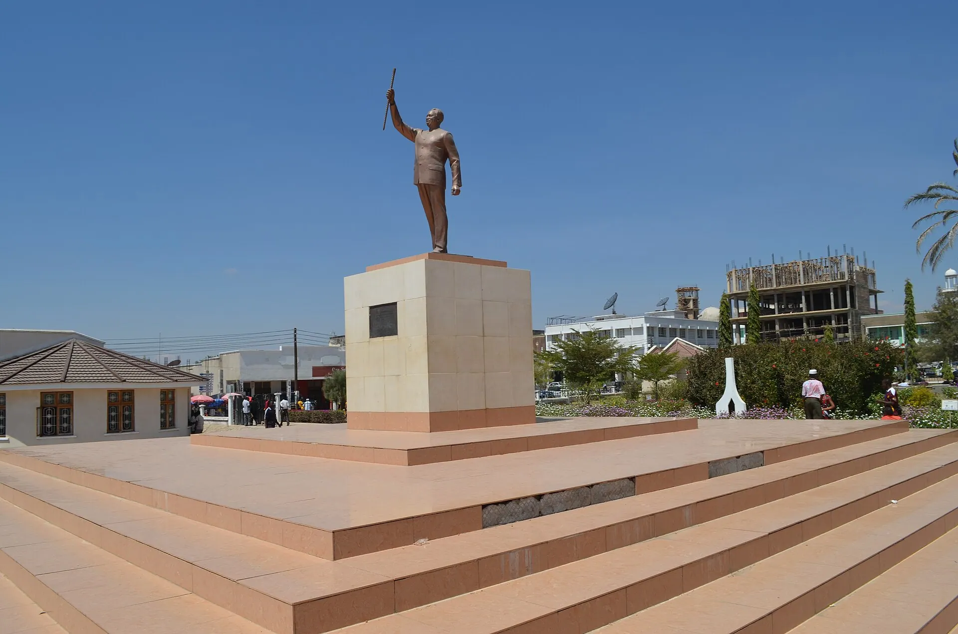 The bronze statue of Julius Nyerere, walking stick raised, on its stone plinth above the wide steps of Nyerere Square in Dodoma, the capital of Tanzania