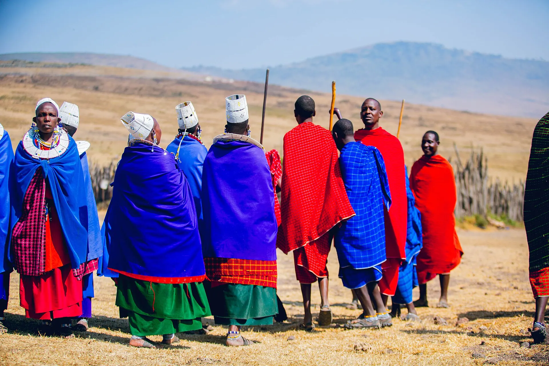 Maasai men and women in red and blue shukas performing a traditional dance in the Ngorongoro highlands